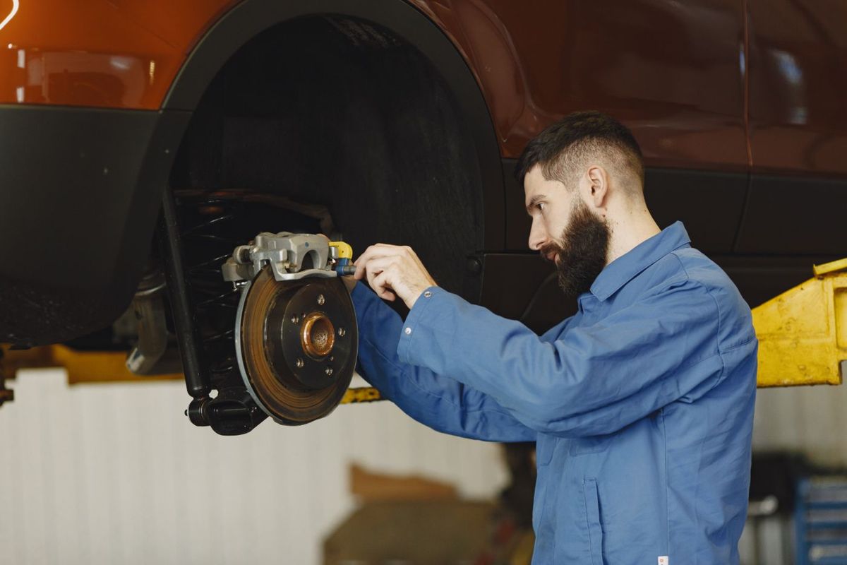 A mechanic fitting a brake disc