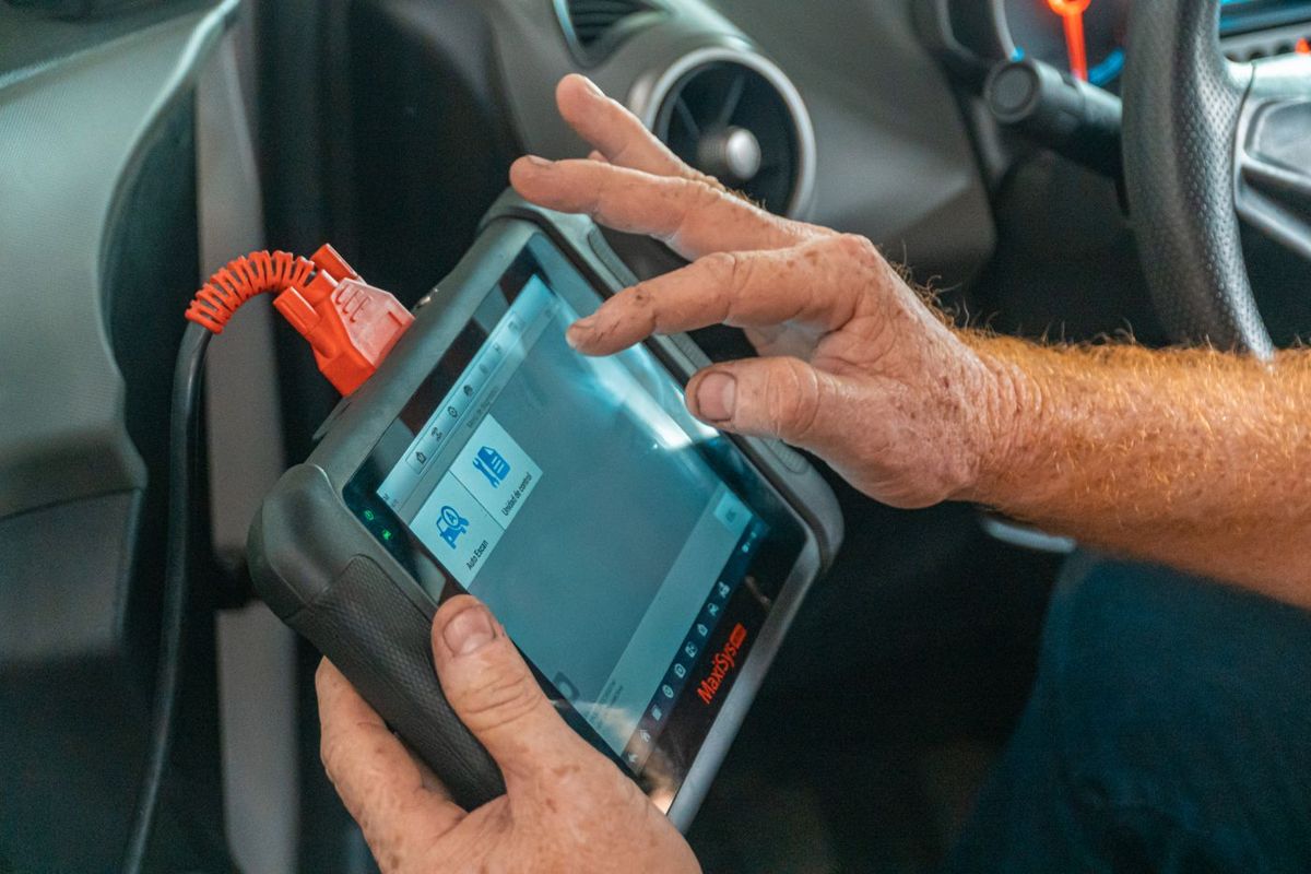 A diagnostic tool plugged into a car